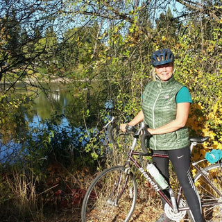 Dr. E, in her mid-60s, enjoying her beloved Bianchi bike along the Spokane River!